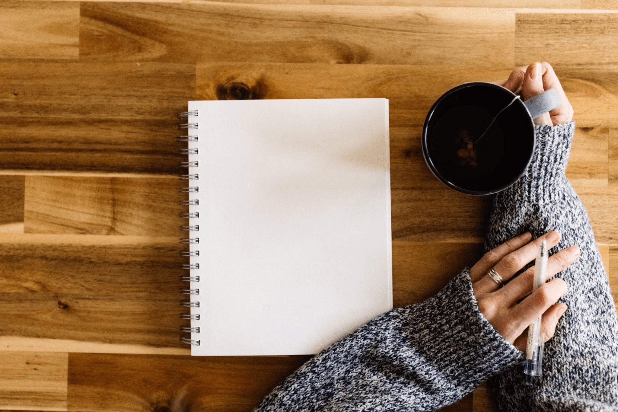 You Don't Need More Ideas— You Need a Plan: 12-Week Summer Writing Intensive 1 Person writing with a cup of coffee